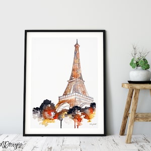 May include: A watercolor painting of the Eiffel Tower in Paris, France. The tower is depicted in shades of brown and orange, with a white background. The painting is framed in a black frame.