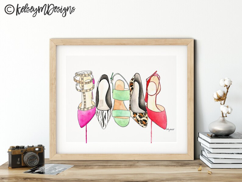 May include: A watercolor painting of five different high-heeled shoes. The shoes are in various colors and patterns, including pink, black and white zebra print, green, leopard print, and red. The shoes are arranged in a row, with the heels facing the viewer.