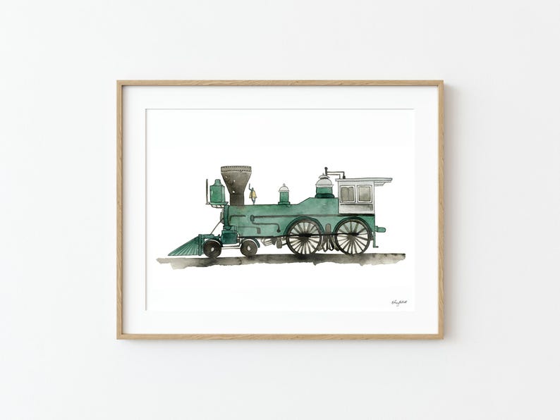 May include: Watercolor painting of a vintage green steam train in a wooden frame. The train features a black smokestack, large wheels, and a small white cabin. The artwork is on a white background.