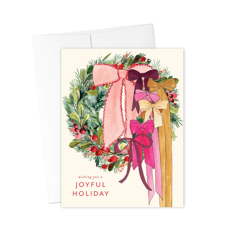 May include: A watercolor illustration of a Christmas wreath with pink, burgundy, and gold bows. The wreath is decorated with green leaves and red berries. The text "Wishing you a Joyful Holiday" is written below the wreath.