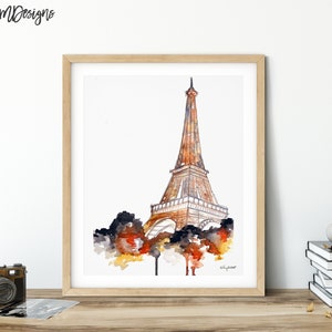 May include: A watercolor painting of the Eiffel Tower in Paris, France. The tower is depicted in shades of brown and gold, with a white background. The painting is framed in a light wood frame.