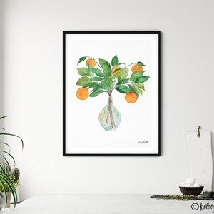 May include: A watercolor painting of a vase filled with orange blossoms and green leaves. The vase is clear glass and has a round shape. The painting is framed in black.