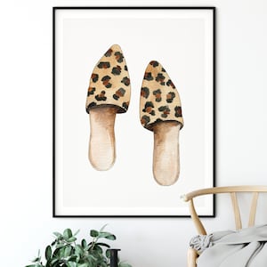 May include: A watercolor painting of a pair of leopard print slippers. The slippers are brown and black with a white background.