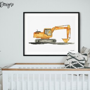 May include: Watercolor painting of an orange excavator in a black frame. The construction vehicle is depicted on a white background. The artwork is displayed above a white crib with a plant and decorative pillows.