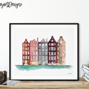 May include: Watercolor painting of a row of five colorful buildings with windows and doors. The buildings are painted in shades of red, pink, purple, brown, and gray. The buildings are set against a light blue background with a green waterline at the bottom.