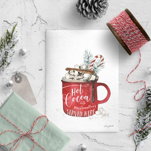 May include: A watercolor illustration of a red mug filled with hot cocoa, topped with whipped cream, marshmallows, cinnamon sticks, and a candy cane. The text reads "Hot Cocoa with marshmallows SERVED HERE".