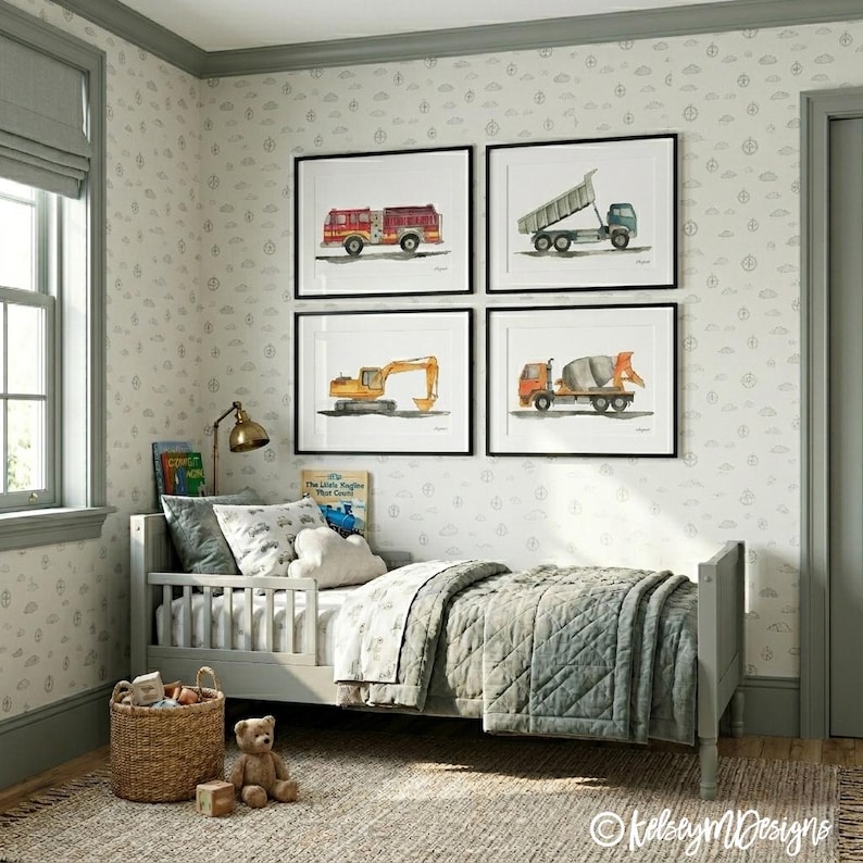 May include: A child's bedroom featuring a gray bed with a quilted blanket and decorative pillows. Above the bed are four framed watercolor prints of construction vehicles: a fire truck, dump truck, excavator, and cement mixer. The room has light gray walls and a patterned wallpaper.