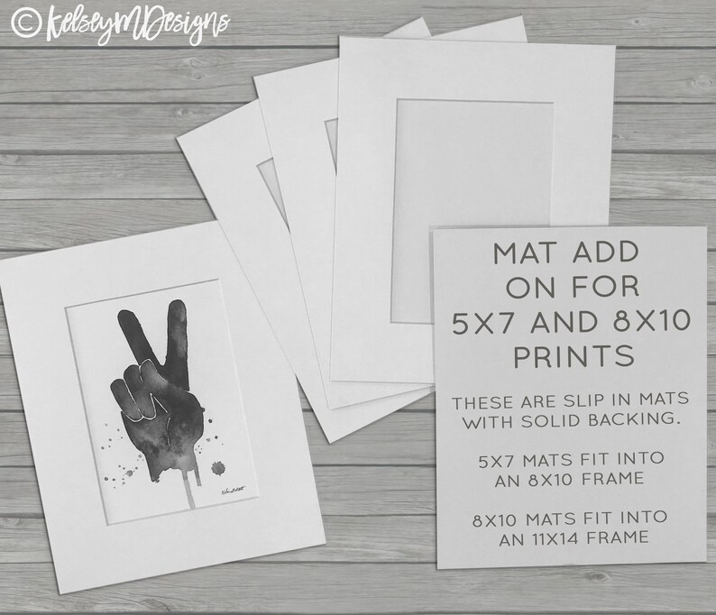 May include: Four white mat boards with cutouts for 5x7 and 8x10 prints. The text on the mat board reads "MAT ADD ON FOR 5X7 AND 8X10 PRINTS THESE ARE SLIP IN MATS WITH SOLID BACKING. 5X7 MATS FIT INTO AN 8X10 FRAME 8X10 MATS FIT INTO AN 11X14 FRAME"