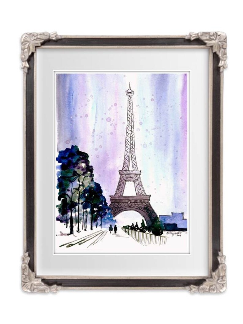 May include: A watercolor painting of the Eiffel Tower in Paris, France. The tower is depicted in black ink against a purple and blue watercolor background. There are trees and people in the foreground.