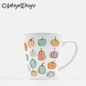 May include: White ceramic mug with a tapered design and a handle. The mug features a pattern of colorful pumpkins in various shades of orange, green, blue, and purple.