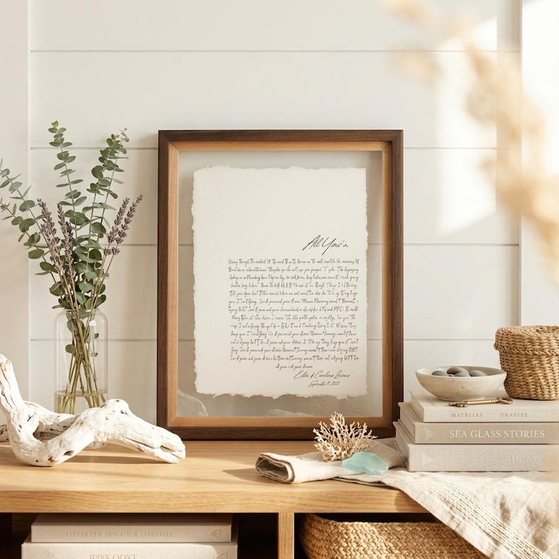 Personalized first dance song lyrics printed on handmade deckled-edge cotton paper and beautifully displayed in a premium float frame. This custom wedding keepsake features the lyrics from a couple's first dance song, creating a meaningful anniversary gift or wedding memory. Elegant home decor crafted from luxurious cotton paper with visible deckled edges. Perfect for weddings, anniversaries, newlyweds, and romantic gift-giving, preserving a special moment in timeless artwork.
