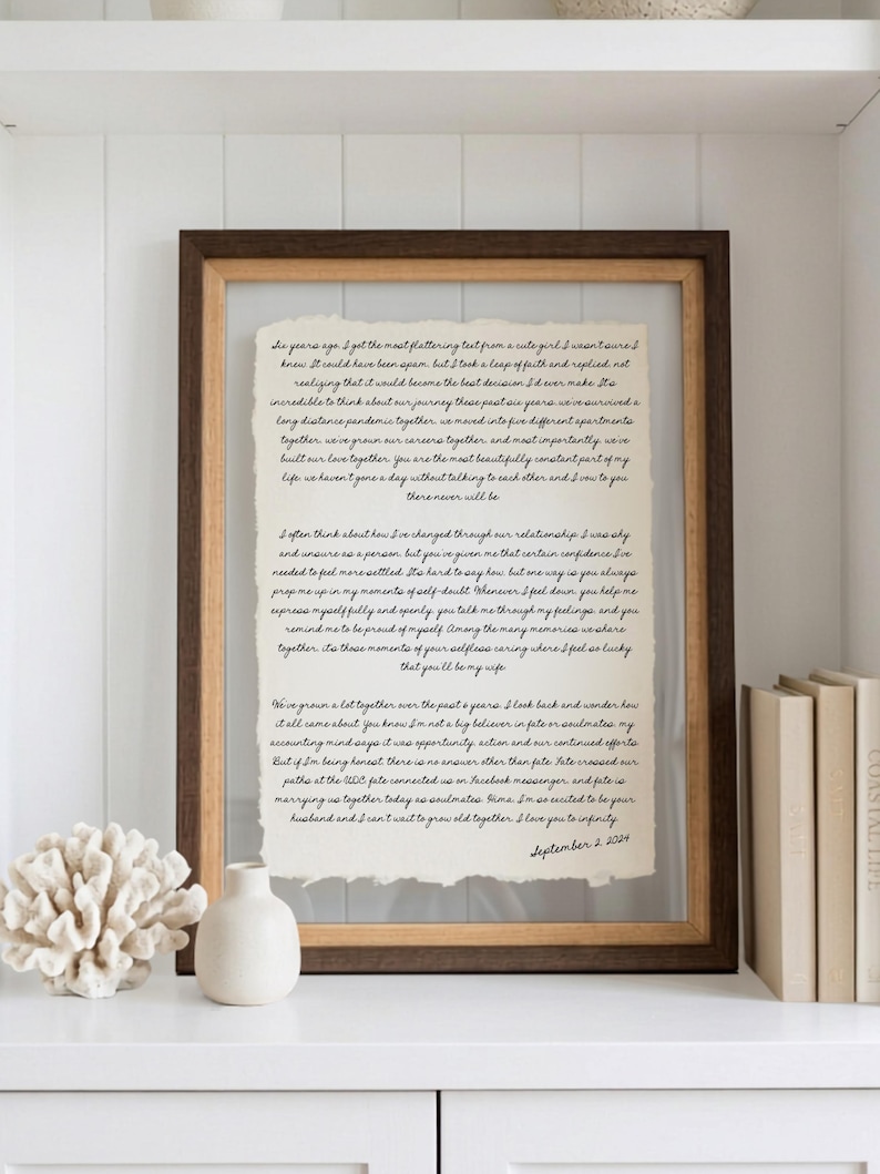 May include: A rectangular wooden frame containing a piece of off-white paper with deckled edges. The paper features black cursive text detailing a personal narrative about a six-year relationship, concluding with the date September 2, 2024.