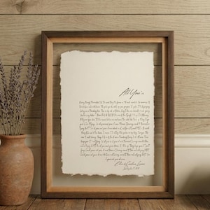 Personalized first dance song lyrics printed on handmade deckled-edge cotton paper and beautifully displayed in a premium float frame. This custom wedding keepsake features the lyrics from a couple's first dance song, creating a meaningful anniversary gift or wedding memory. Elegant home decor crafted from luxurious cotton paper with visible deckled edges. Perfect for weddings, anniversaries, newlyweds, and romantic gift-giving, preserving a special moment in timeless artwork.