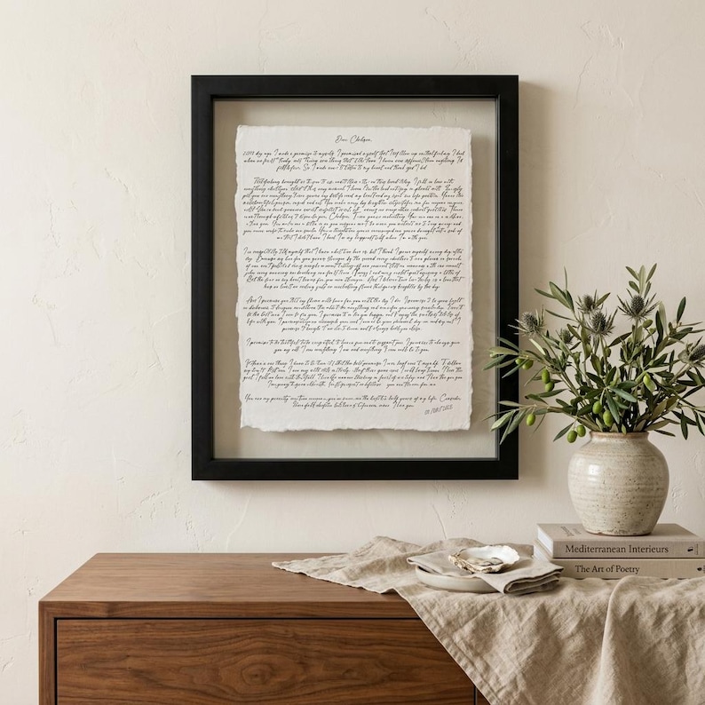 Custom anniversary keepsake with wedding vows displayed on handmade cotton paper and framed in a luxury walnut float frame.