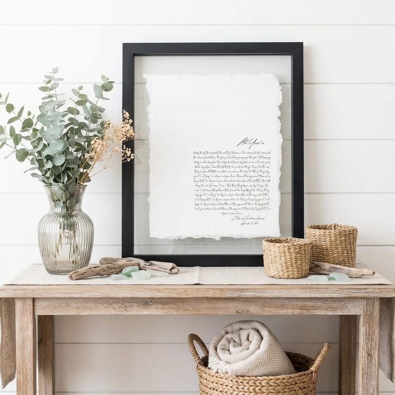 Personalized first dance song lyrics printed on handmade deckled-edge cotton paper and beautifully displayed in a premium float frame. This custom wedding keepsake features the lyrics from a couple's first dance song, creating a meaningful anniversary gift or wedding memory. Elegant home decor crafted from luxurious cotton paper with visible deckled edges. Perfect for weddings, anniversaries, newlyweds, and romantic gift-giving, preserving a special moment in timeless artwork.