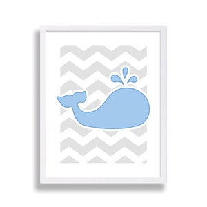May include: A framed print with a light blue whale silhouette on a gray chevron background.