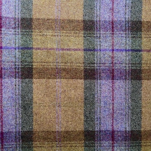 May include: A woven fabric featuring a plaid pattern with intersecting vertical and horizontal lines in shades of tan, dark brown, forest green, and bright purple, creating a textured surface with a visible cross-hatched weave structure.