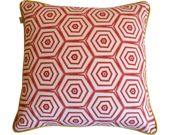 Puede incluir: Cojín decorativo con un patrón geométrico rojo y blanco y un borde amarillo.
