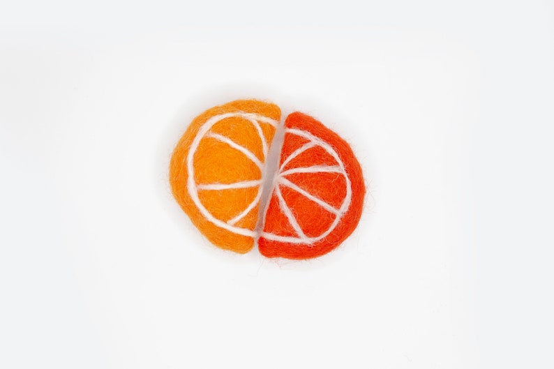 May include: Two felt orange slices, one orange and one red, with white felt lines for the segments. The slices are joined together.