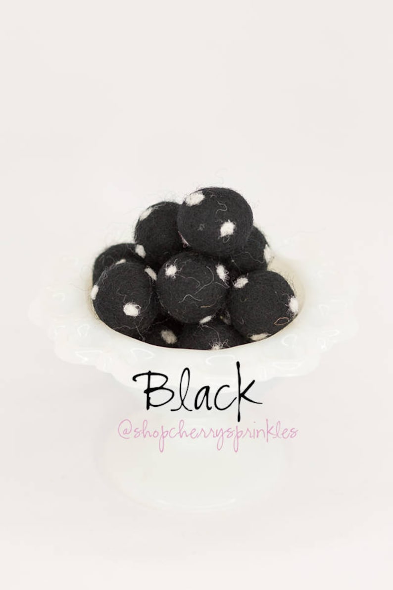 May include: A bowl of black felt balls with white polka dots. The text "Black" and "@shopcherryzsprinkles" is below the bowl.