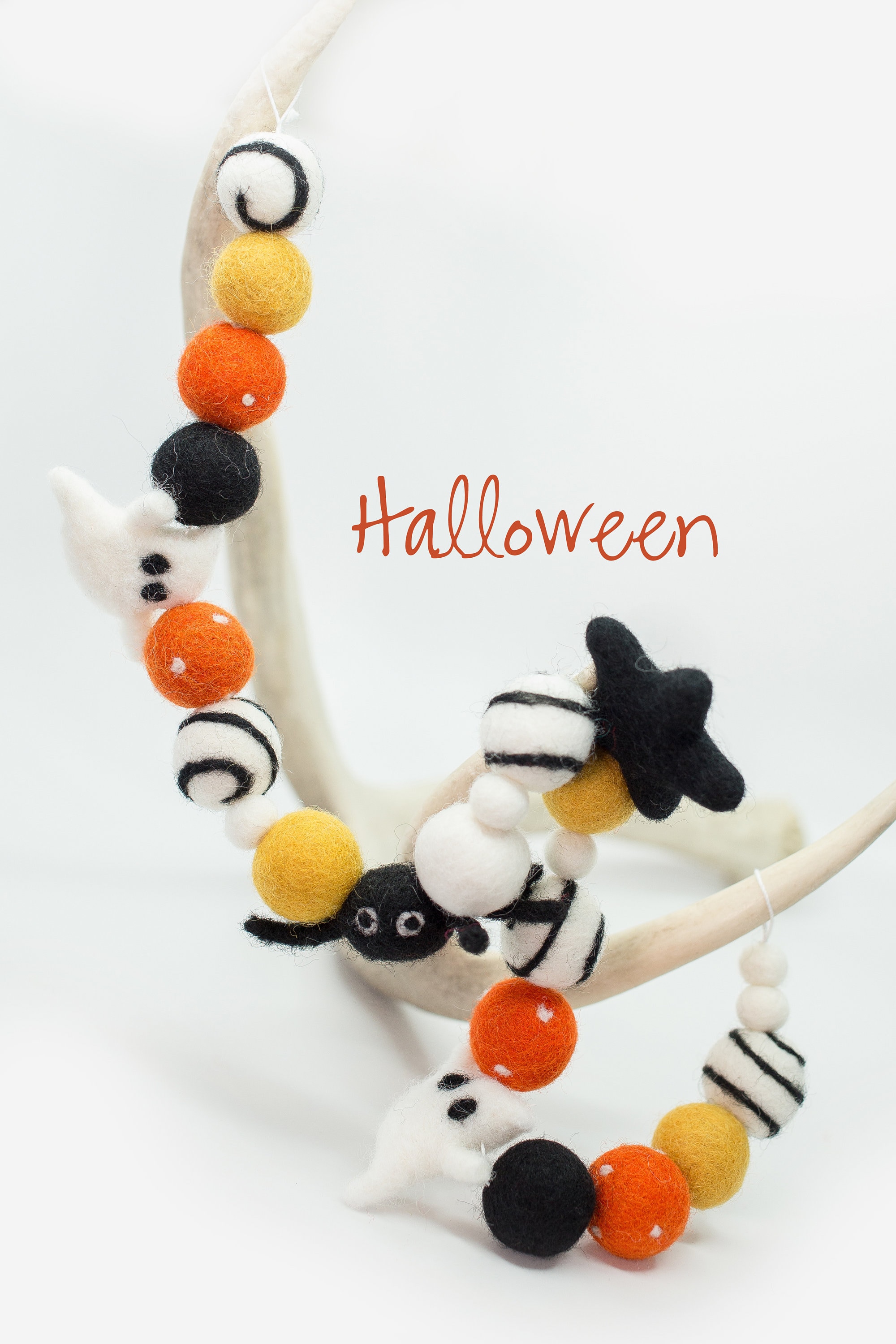 Felt Halloween spider ornament, thread, needle, paper templates, filler,  white and black felt sheets on a