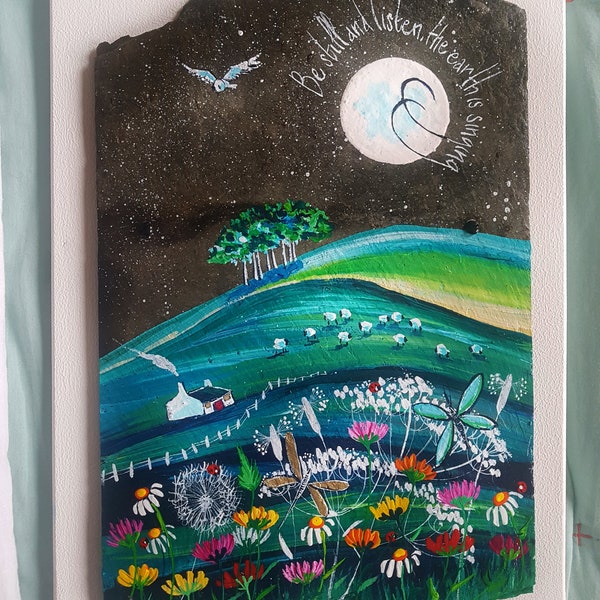 White cottage on a sheep filled hill. Original painting on slate. With the words 'Be still and listen, the earth is singing'. Free delivery!