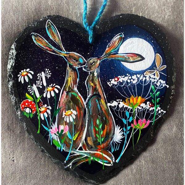 Love story hares kissing under full moon.  Handpainted on a large slate 25cm heart. Words can be added