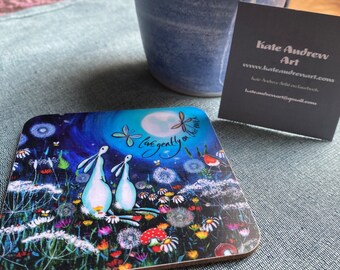 Coaster with hares looking at the moon with ‘live gently on this earth'. Wild flowers and vivid colours. Free gift box when you buy four.