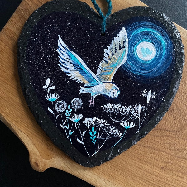 Barn Owl in flight above wild flowers, with the full moon in the sky. Hand painted on a 18cm slate heart.  Celebrating British wildlife