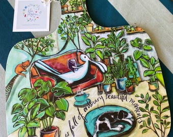 Hare Reading Book surrounded by houseplants and a cat and dog. Melamine Chopping Board, UK Made
