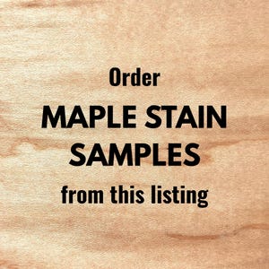 May include: A light tan wood grain surface with a smooth texture. Centered black text reads: Order MAPLE STAIN SAMPLES from this listing. The wood features natural horizontal grain patterns and subtle variations in color throughout the surface.