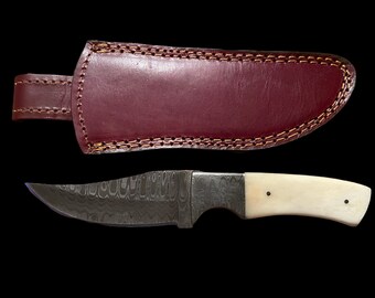 8” Clip Point Bone Hunter, Damascus Steel blade and bolsters, natural bone handle, top grain leather sheath, full tang, stainless pins