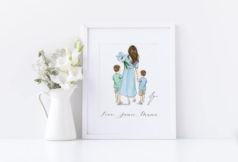 May include: A framed art print featuring a mother and two children. The mother wears a light blue dress and holds a bouquet of blue flowers. The children are in green and blue shirts. The names Finn, Jamie, and Mason are written below.