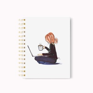 May include: Spiral-bound notebook with a watercolor illustration of a person sitting cross-legged, working on a laptop, and holding a coffee cup. The cup reads "Coffee First". The notebook has a white cover and gold spiral binding.