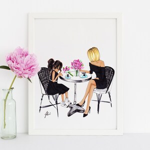 May include: A framed illustration of two people, a woman and a girl, sitting at a table with pink flowers. They are both wearing black dresses and are drinking from cups. The woman has blonde hair and the girl has brown hair.