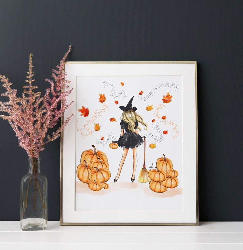May include: A witch in a black dress and a pointed hat walks through a field of pumpkins. The witch is holding a broom and a small pumpkin. The background is a white watercolour wash with autumn leaves and sparkles.
