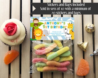 May include: A blue and white favor bag with a jungle animal theme. The bag has a sticker that says "Anthony's 1st Birthday" and includes the text "Thank you for celebrating with me! Love, Anthony". The bag is filled with colorful gummy worms.