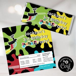 May include: A green, black, yellow, and red birthday party favor chocolate bar wrapper with a paintball gun graphic and the text "Jackson's 3rd Birthday Paintball Party!"  The wrapper also includes a nutrition facts label with the text "Family - 100%, Friends - 100%, Laughter - 100%, Cake - 100%, Fun - 100%, Smiles - 100%".