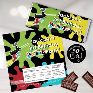 May include: A green, black, yellow, and red personalised chocolate bar wrapper with a paintball gun design. The wrapper says "Jackson's 3rd Birthday Paintball Party!" and "Personalize with Cory!"