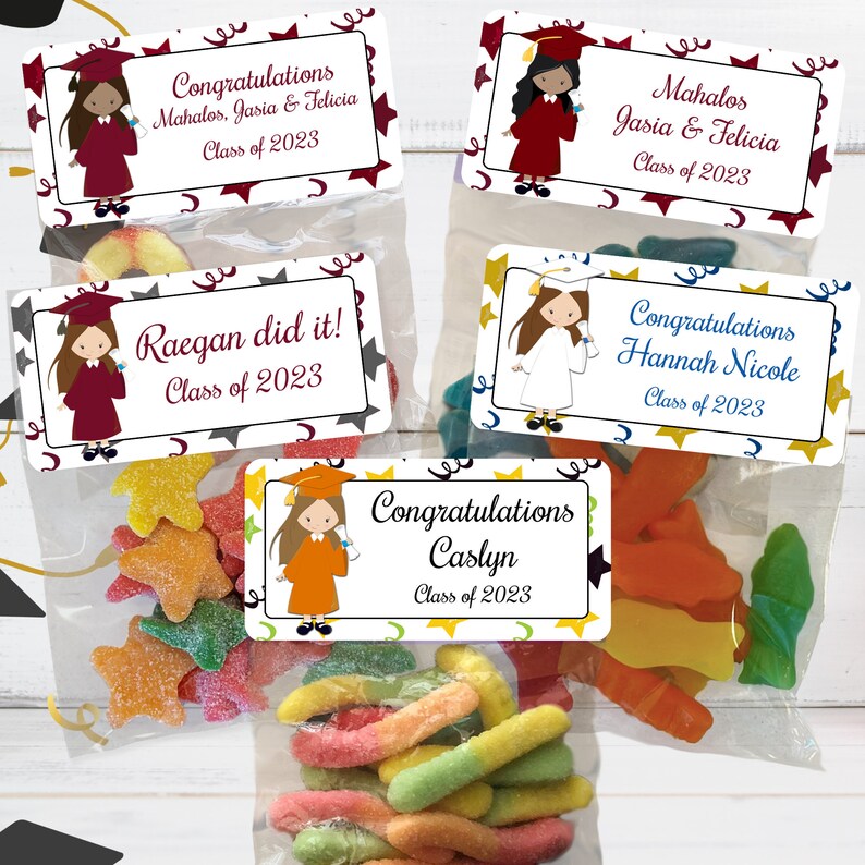 May include: Four graduation party favor bags with colorful candy and personalized labels. The labels feature a cartoon graduate with a cap and gown, and the text "Congratulations", "Mahalos", "Raegan did it!" and "Caslyn".