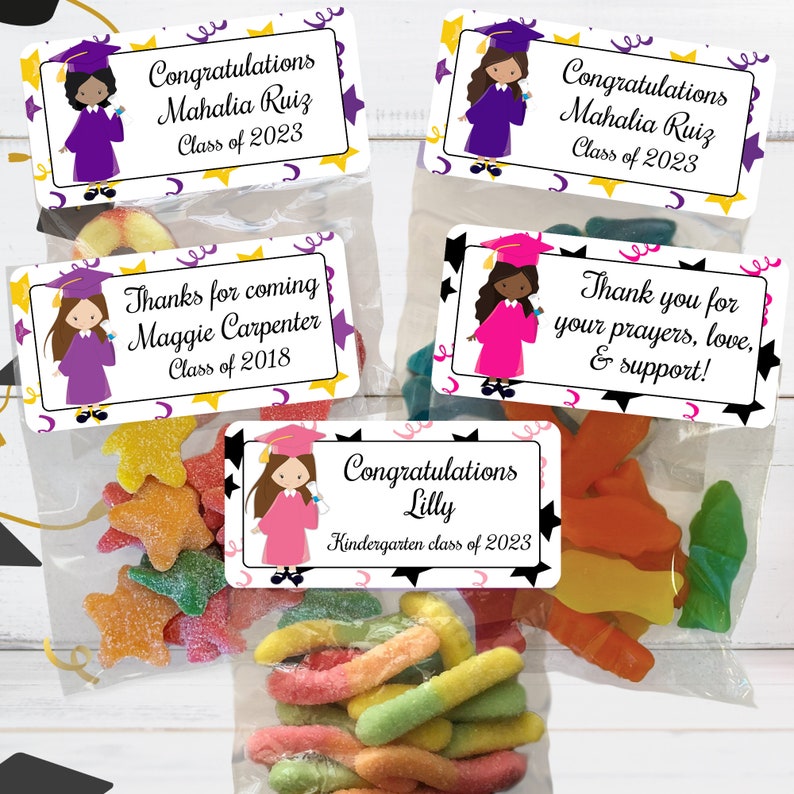 May include: Four graduation party favor bags with colorful candy and personalized labels. The labels feature a cartoon girl in a graduation cap and gown, with the text "Congratulations Mahalia Ruiz Class of 2023", "Thanks for coming Maggie Carpenter Class of 2018", "Congratulations Lilly Kindergarten class of 2023", and "Thank you for your prayers, love, & support!"