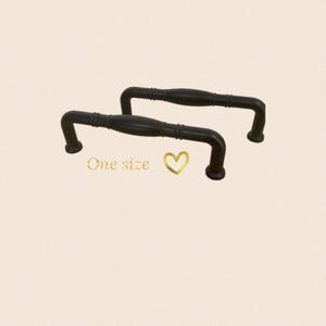 May include: Two black metal cabinet pulls with a simple design. The pulls are approximately 12.5 cm long and have a slight curve. One size.