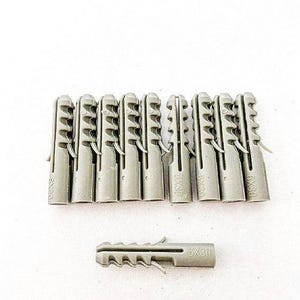 May include: A close-up of ten grey plastic wall anchors with the text "6x30" printed on each. A single grey plastic wall anchor with the text "6x30" is shown in the foreground.