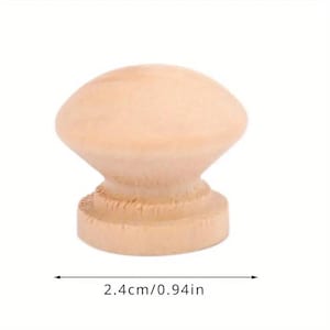 May include: A light brown wooden knob with a rounded top and a slightly flared base. The knob measures 2.4 cm in diameter.