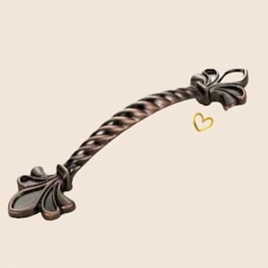 May include: An antique bronze cabinet pull with a twisted design and decorative fleur-de-lis ends.