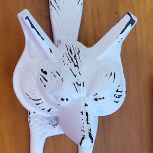 May include: White ceramic fox door knocker with black detailing. The fox has a long, pointed tail and a detailed face.