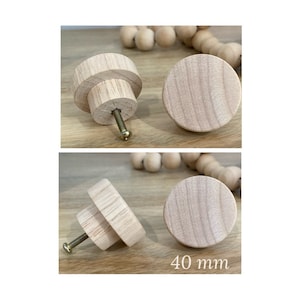 May include: Two wooden knobs with a screw, one knob is shown from the side and the other from the top. The knobs are 40 mm in diameter.