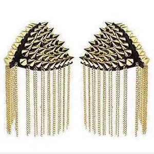 Peut inclure: Une paire d'épaulettes dorées avec un design à pointes cloutées et des chaînes dorées pendantes.
