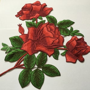 May include: Red embroidered rose flower patch with green leaves.