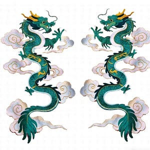 May include: Two embroidered dragons in teal and gold, with detailed scales and flowing forms. Each dragon is surrounded by fluffy white and light pink clouds, creating a dynamic and ornate design. The dragons face each other, suggesting balance and harmony.